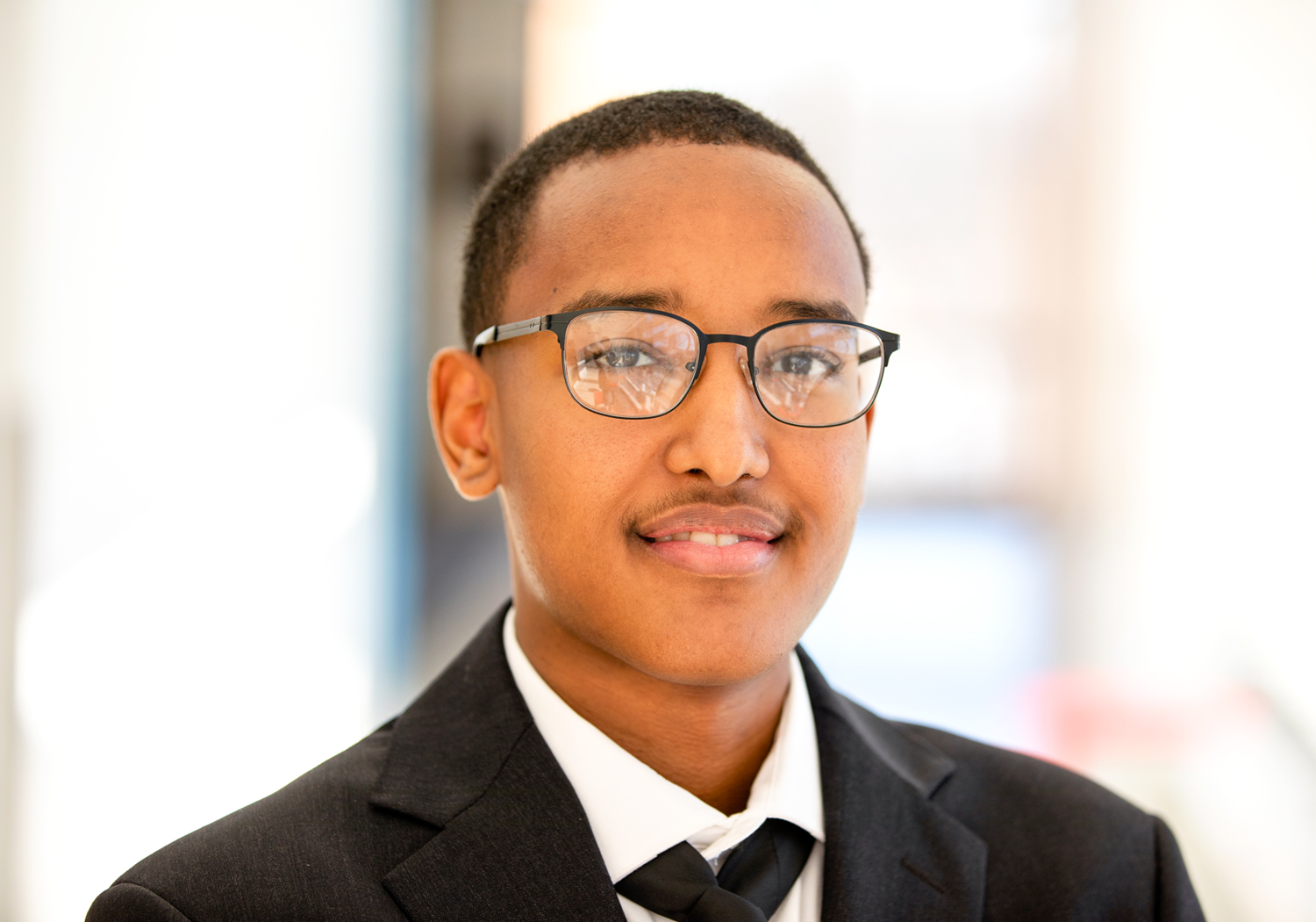 A male Normandale student is smiling at the camera. 