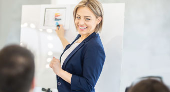 A woman teaches at a white board.