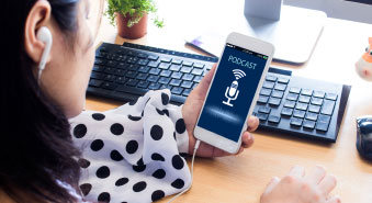 Woman wearing ear bugs and looking at phone