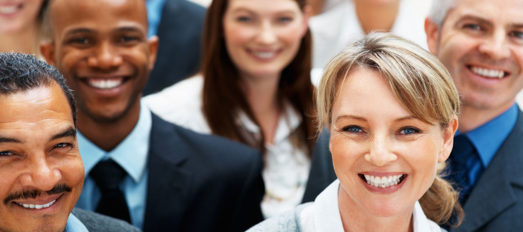 Group of people smiling in a crowd