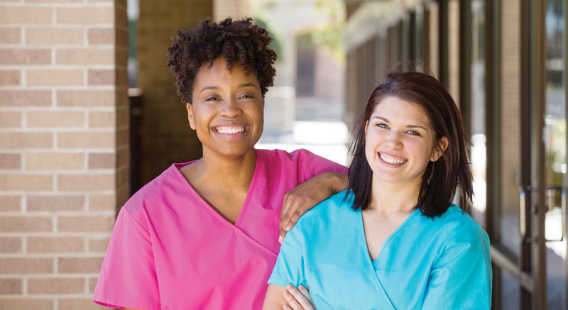 Two happy career women smiling