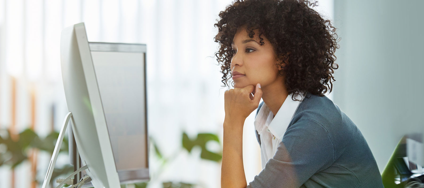 Woman taking an online professional development course on a computer.