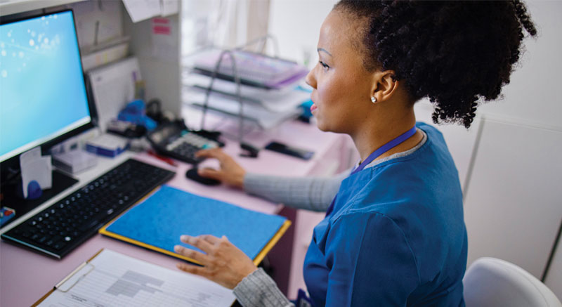 Medical coding and billing professional at computer
