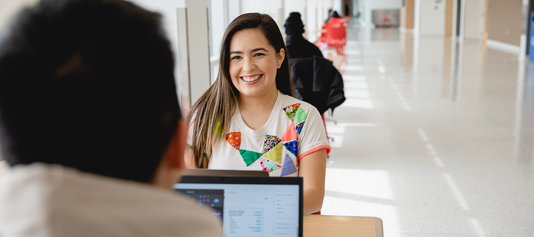  A Normandale student smiles at another student.