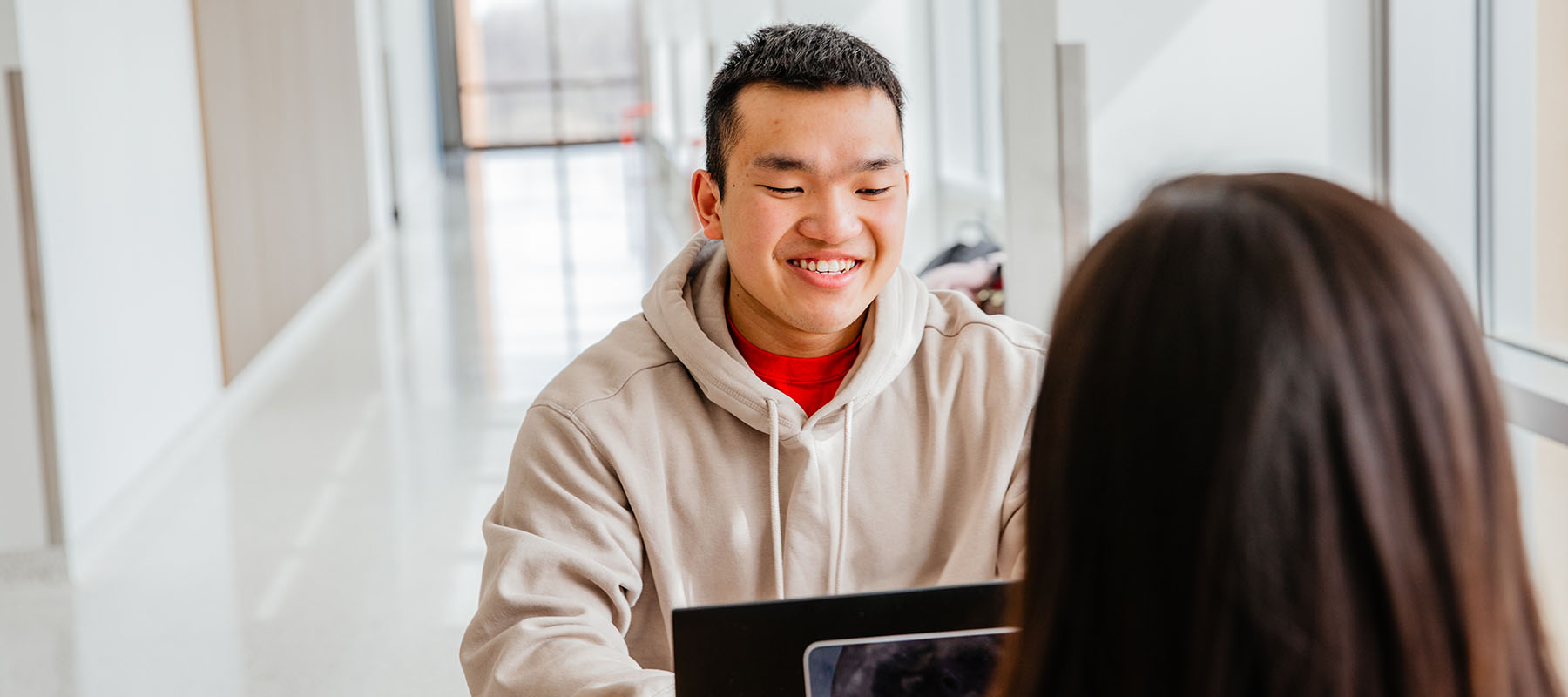 A Normandale student helps another student.