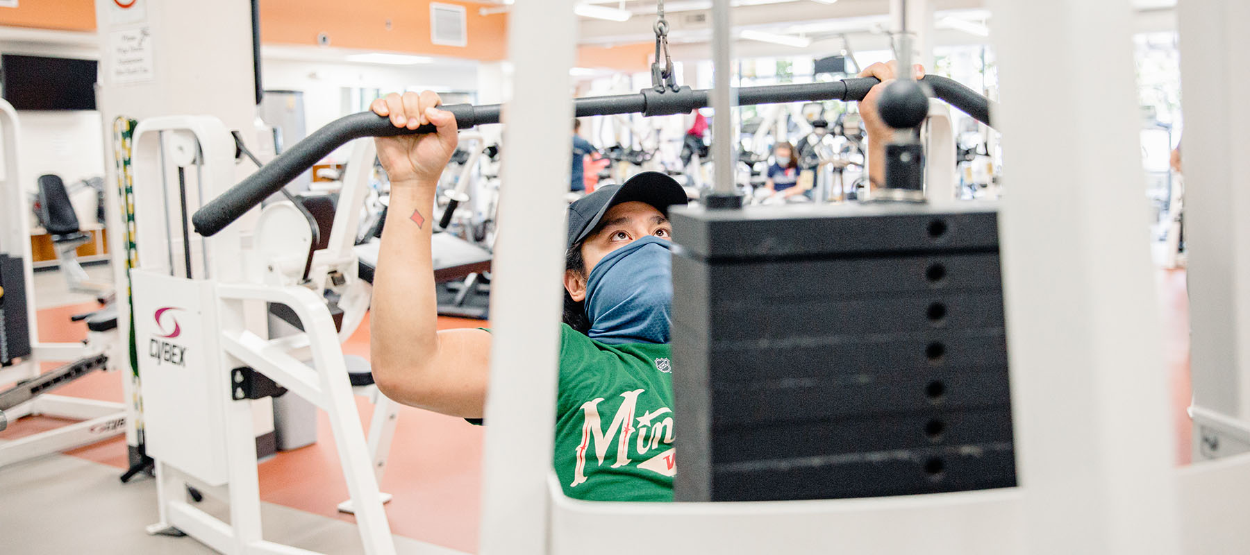 A student uses a weight machine in the fitness center.