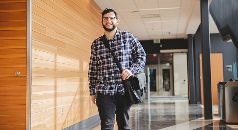 A student walks down a hallway.