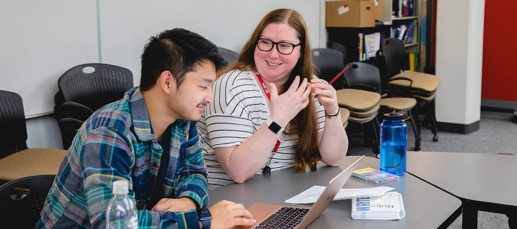 A student and tutor work together. 