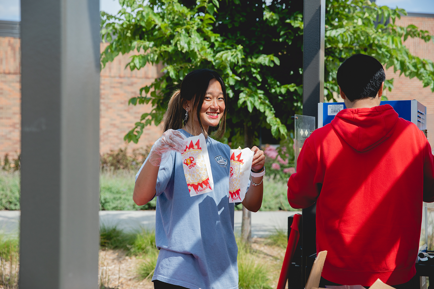Student holding popcorn