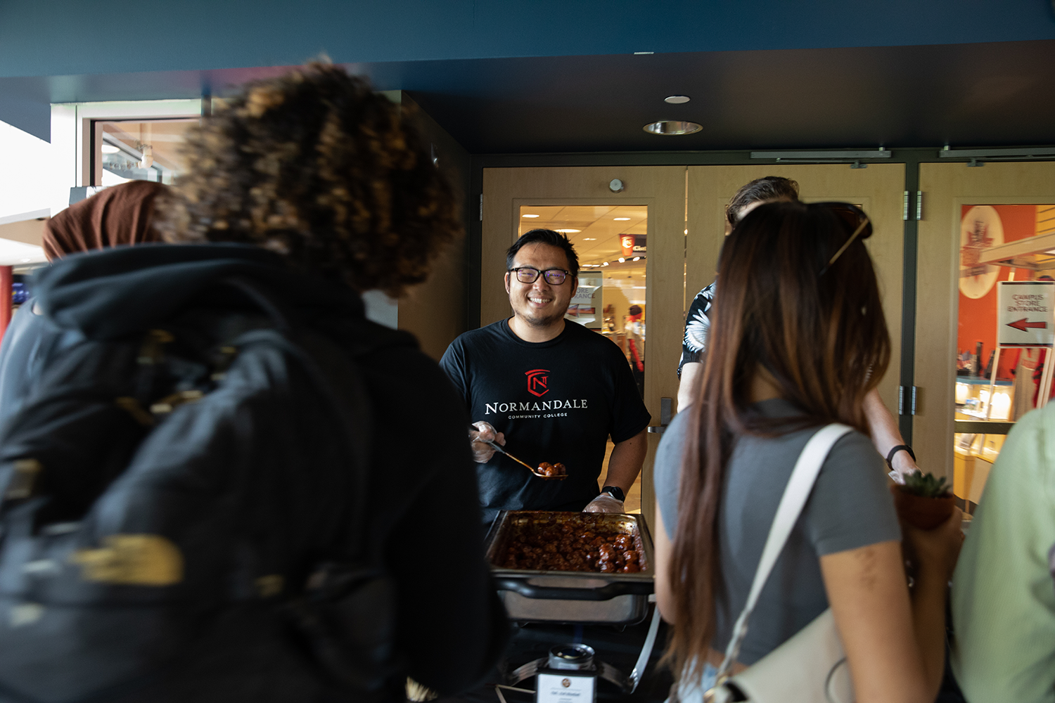 Normandale student serving food