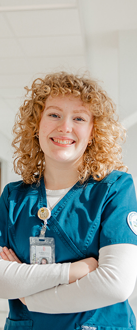 A Normandale nursing student in scrubs.