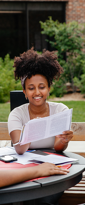 A Normandale student studies outside.
