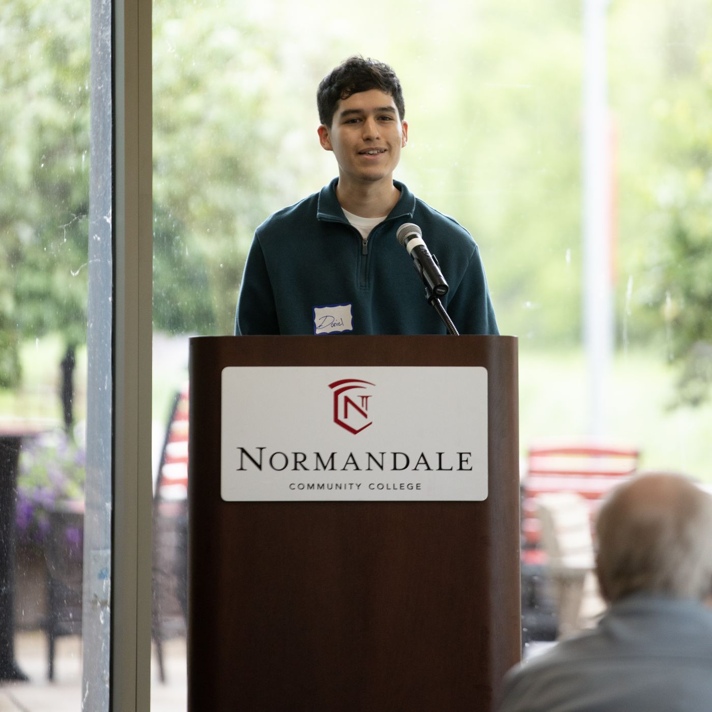 Program Graduate Daniel Sanchez speaks to partners and audience