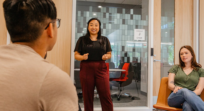 A Coach speaks with students. 