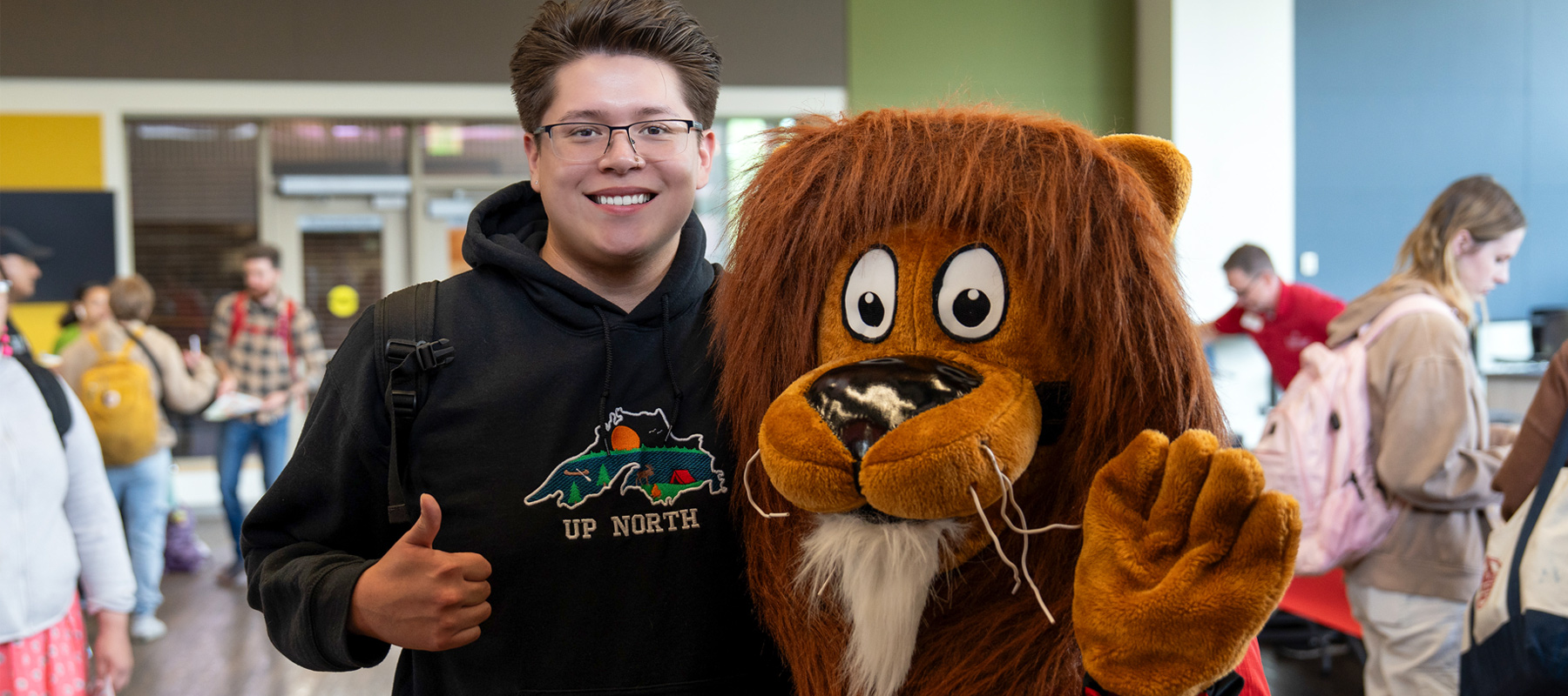 A Normandale alumnus with Norm the Lion