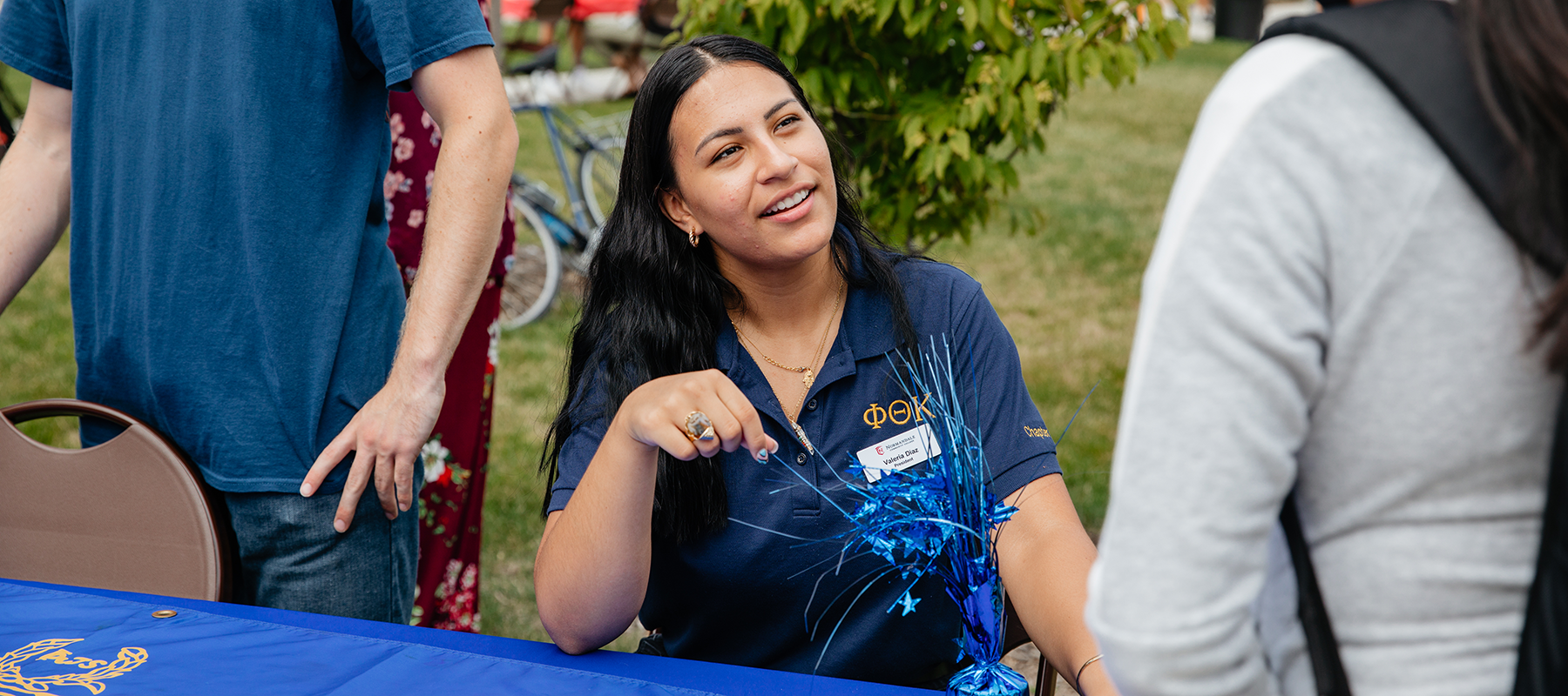 Normandale student leader Val Diaz talks with a student.