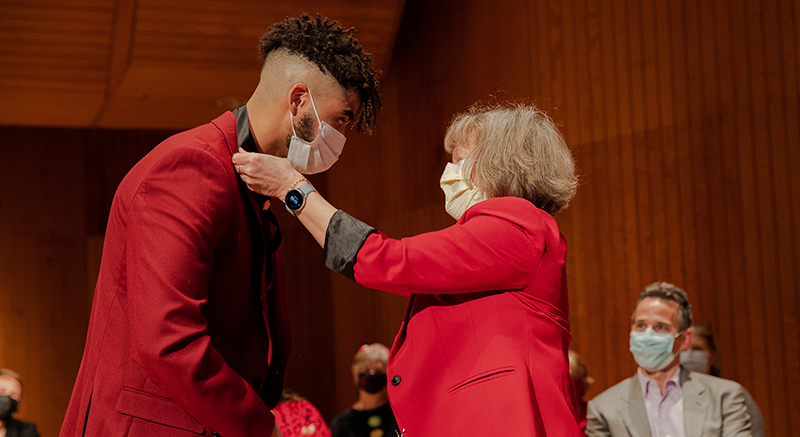 A Normandale nursing faculty member pins a student at the Nurse Pinning Ceremony.
